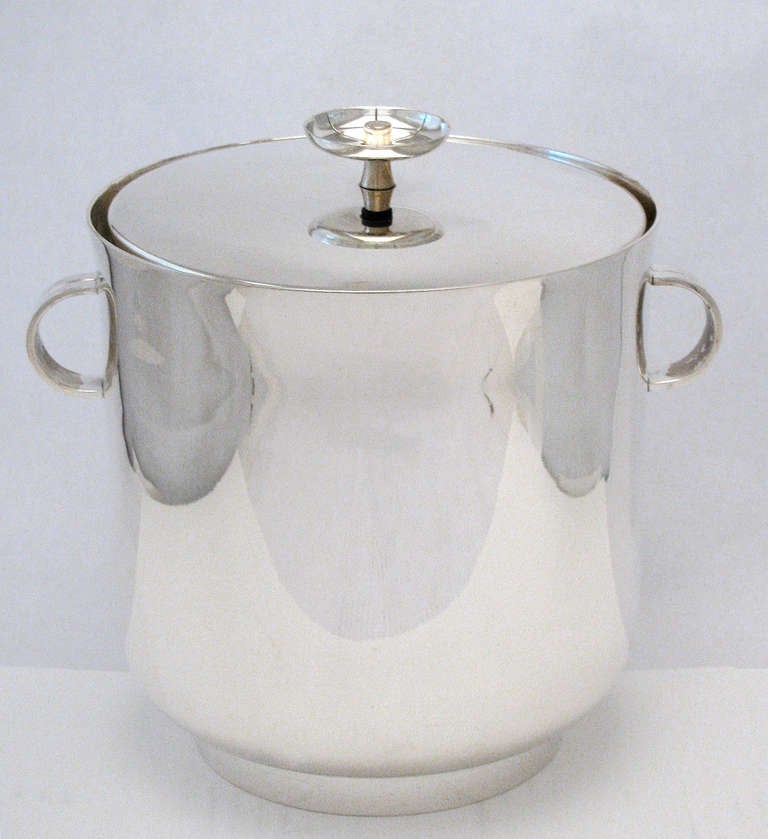 A rare pair of silver plate ice coolers or buckets by Tommi Parzinger for Dorlyn Silversmiths. Both are similar in dimensions with detailing on the lids to be slightly different; one for chilling champagne or wine, and the other for ice cubes for
