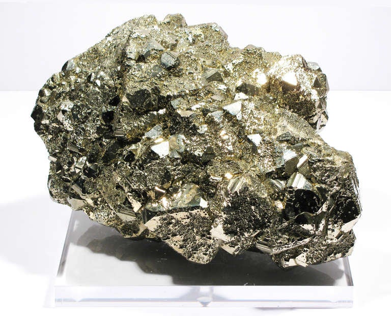 A highly aesthetic mound of dazzling Pyrite pyritohedra, resting on a thick lucite base. Large cabinet size in excellent condition. This amazing specimen of pyrite, with it's metallic lustre and yellowish color makes it clear why this mineral is