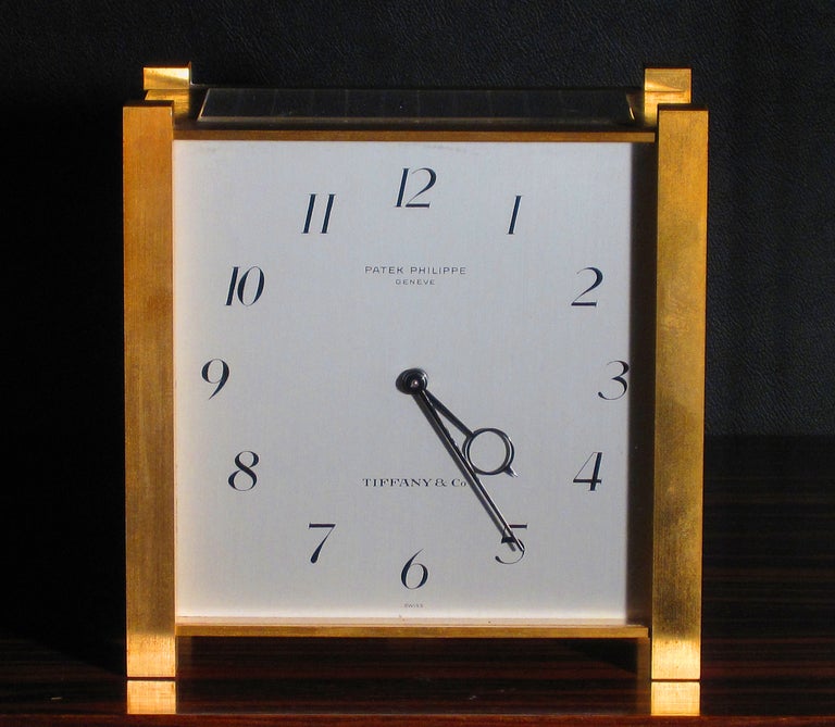 A square gilt brass solar-powered desk clock signed Patek Philippe, Geneve, retailed by Tiffany and Company, movement number 873911, case number 1570, manufactured in 1967. Gilt-finished lever movement, 29 jewels, Gyromax balance, free sprung