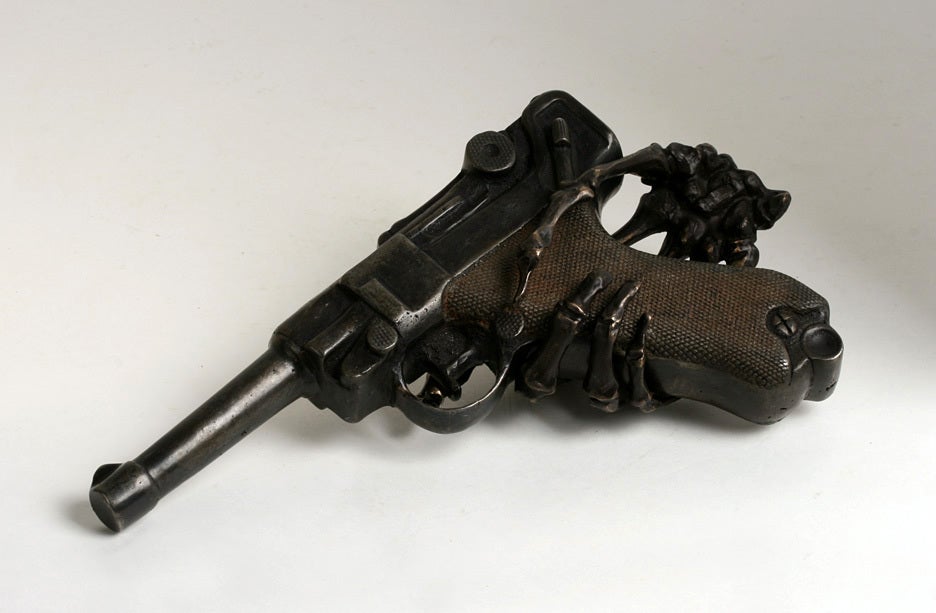 skeleton hand holding revolver