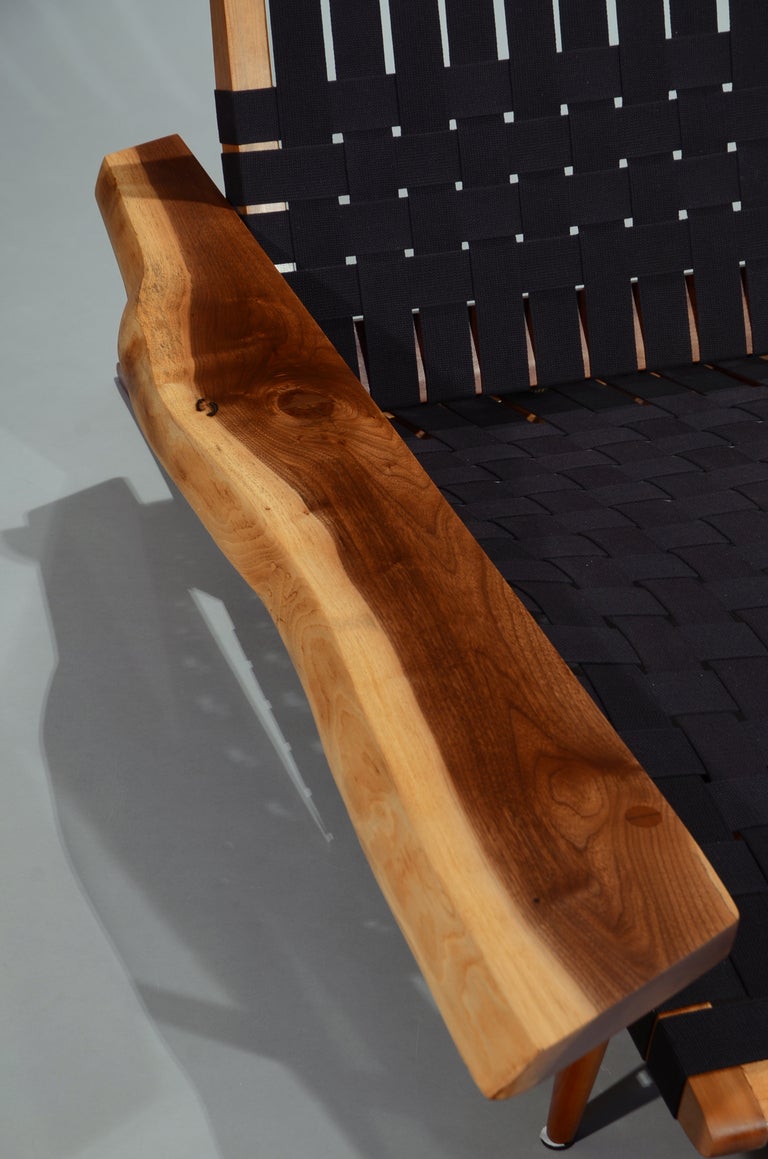 Iconic modernist design by Nakashima with a beautiful walnut arm and cherry frame