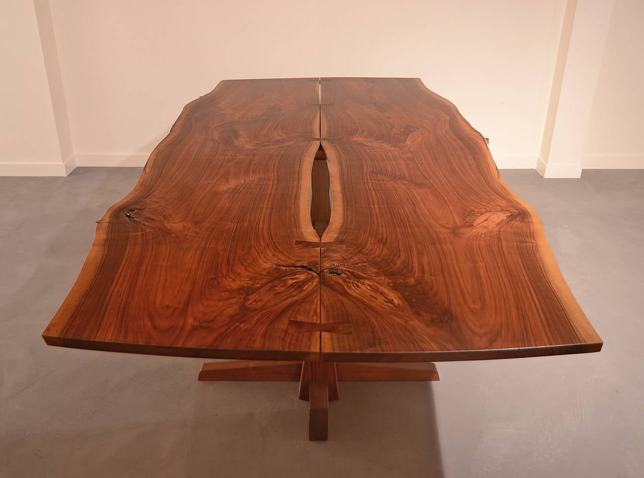 Striking, massive and rare dining table by George Nakashima. Bookmatched, highly figured top with free sap edges and five butterflies.