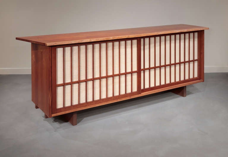 Beautiful cherry cabinet with sliding, grilled pandanus cloth doors.  Doors and top are referred to by Nakashima as 