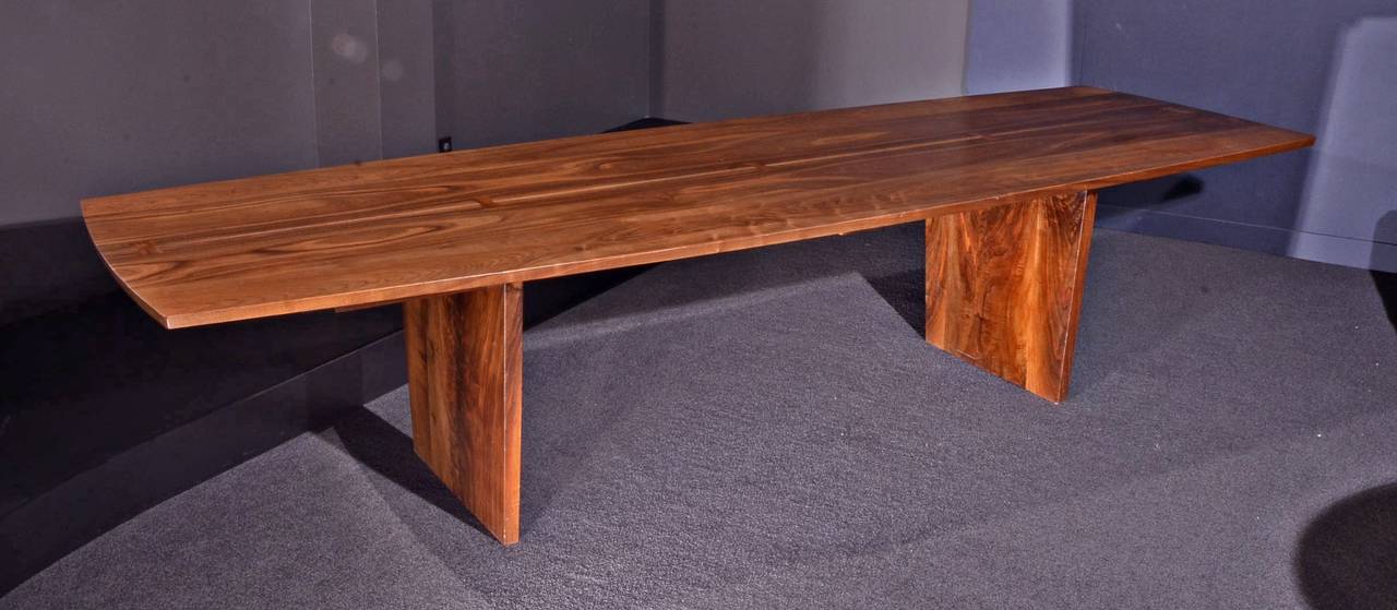 One of the largest tables made by George Nakashima. This features a highly figured American black walnut, boat shaped top with five butterfly joints. Measure: 10.5 feet.