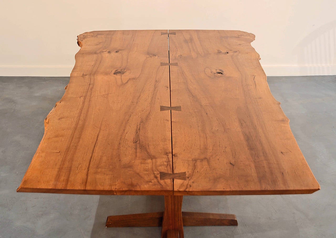 A very rare wood for Nakashima, he only used bloody birch for several pieces in the 1970s. Two board bookmatched top with four butterfly joints on an American black walnut base, with particularly dramatic free edges. A copy of the original Nakashima