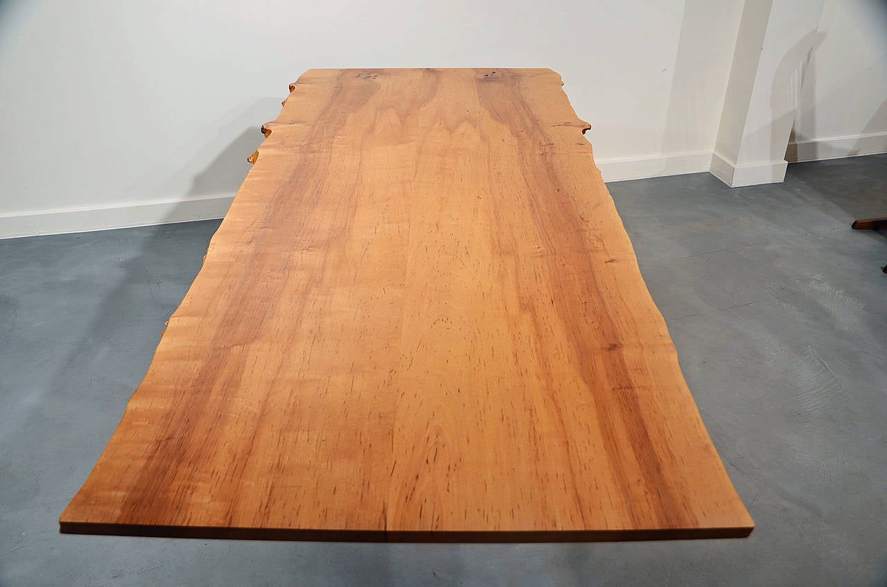 A unique, custom desk design in a very rare wood, bloody birch, that was only used on several Nakashima pieces in the 1970s. Designed for an author, the height of the desk top is an ergonomically correct 26