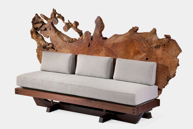 American black walnut sofa with 5” cushions in Jack Lenor Larsen fabric, backed by a spectacular Maple root burl. Designed by Mira Nakashima. Crafted by Alyssa Francis.