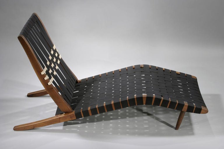 A rare, early version of the iconic Long Chair by George Nakashima.    One of the very few examples which incorporated sea-grass into the design of the back.