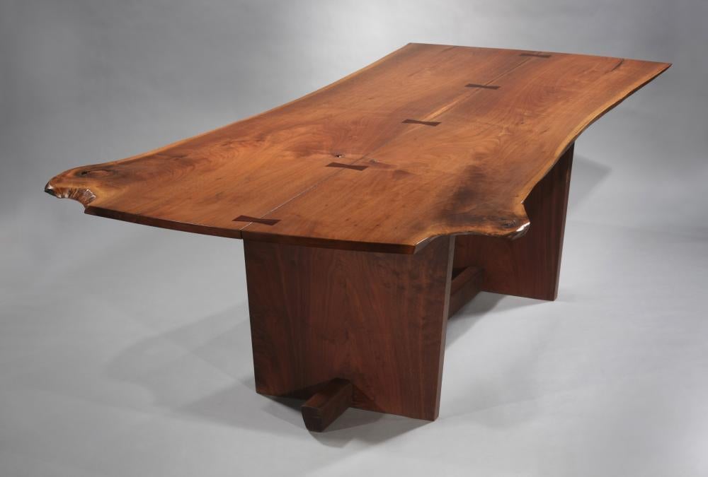 Rare dining table form by Nakashima.  American black walnut bookmatched top with 5 rosewood butterflies