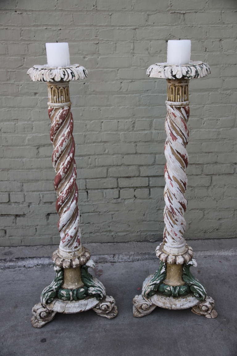 Pair of French carved wood painted torchieres standing on a tripod base with acanthus leaf details throughout.