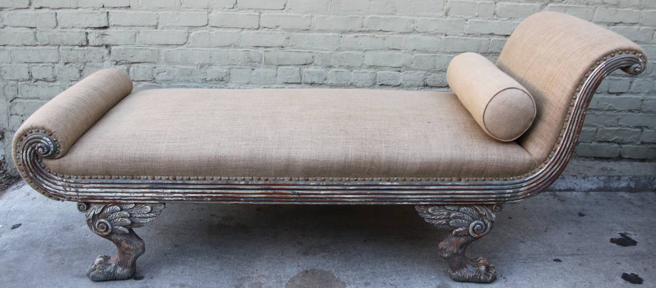 Early 20th century carved painted American Regency style chaise with winged paw feet. Newly upholstered in burlap textile with nailhead trim detail.