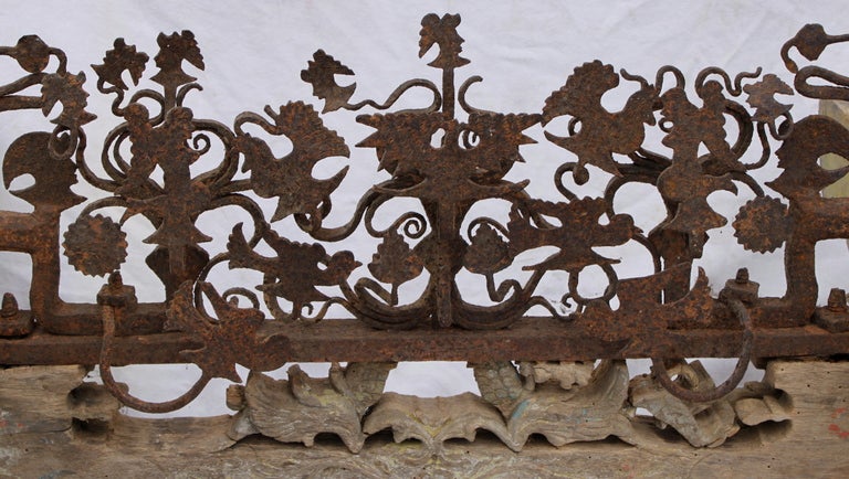 Rare18th century wedding cart axle bracket with carved wood and forged iron decoration depicting doves, mermaids, roosters, and many other wonderful objects and figures.  