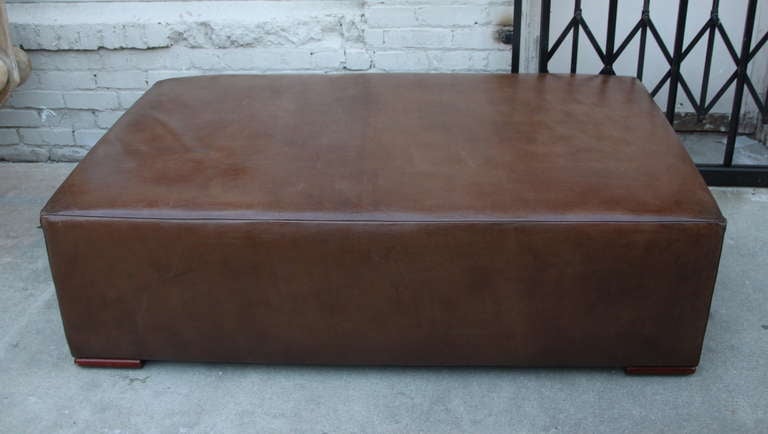 Ralph Lauren Home Leather Ottoman with square wood feet.