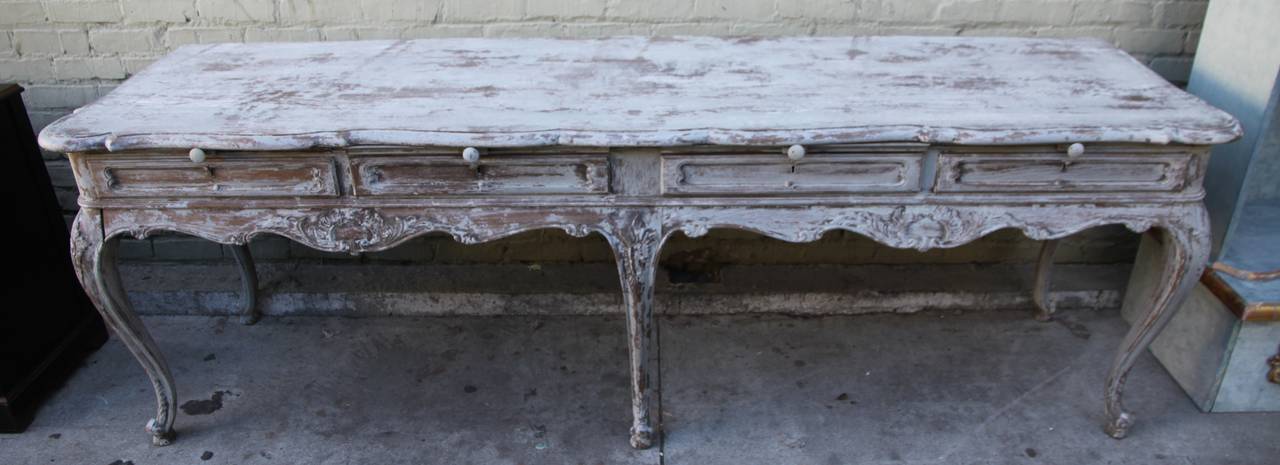 19th century French painted table standing on six cabriole legs.  Four drawers and four pull-outs for additional space.