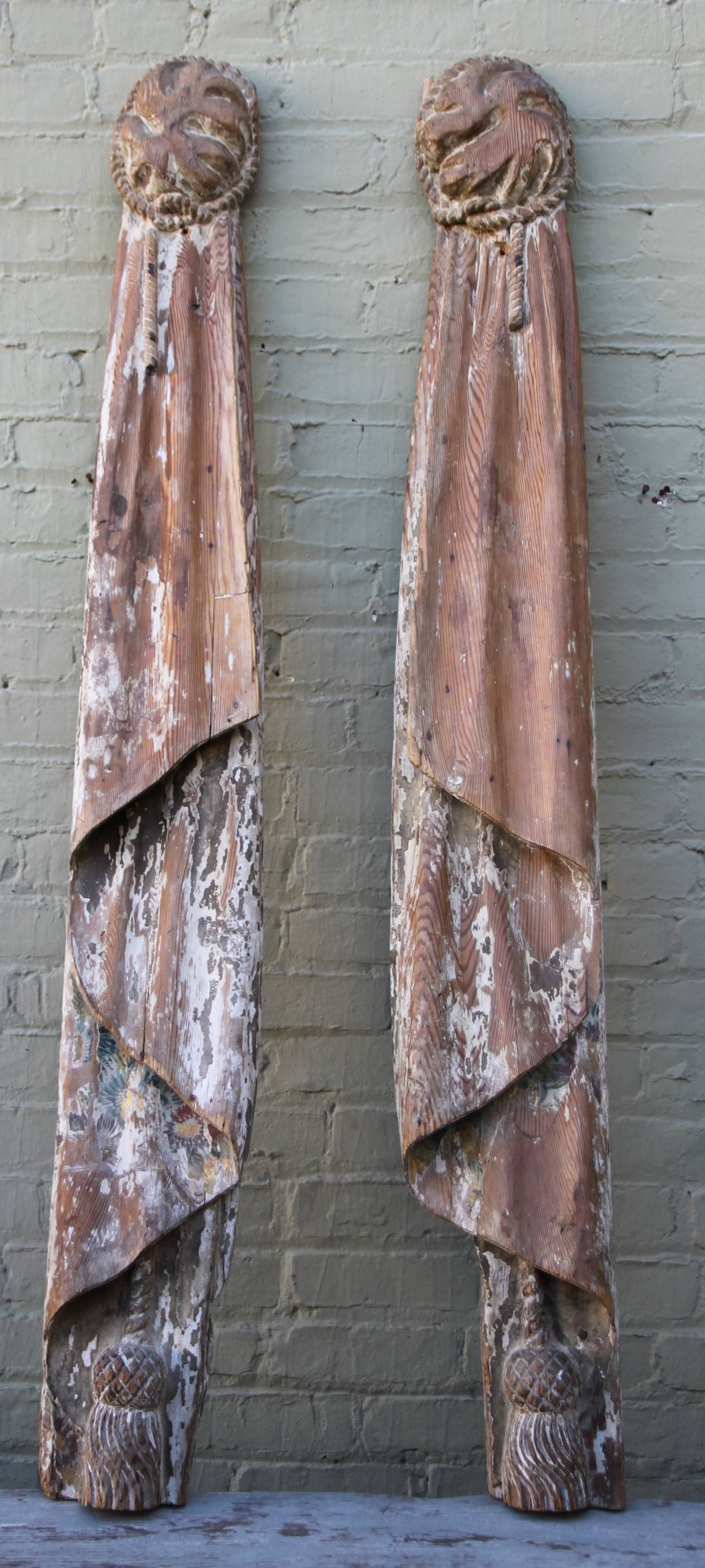 Monumental pair of 19th century Italian carvings of drapery panels with tassels.