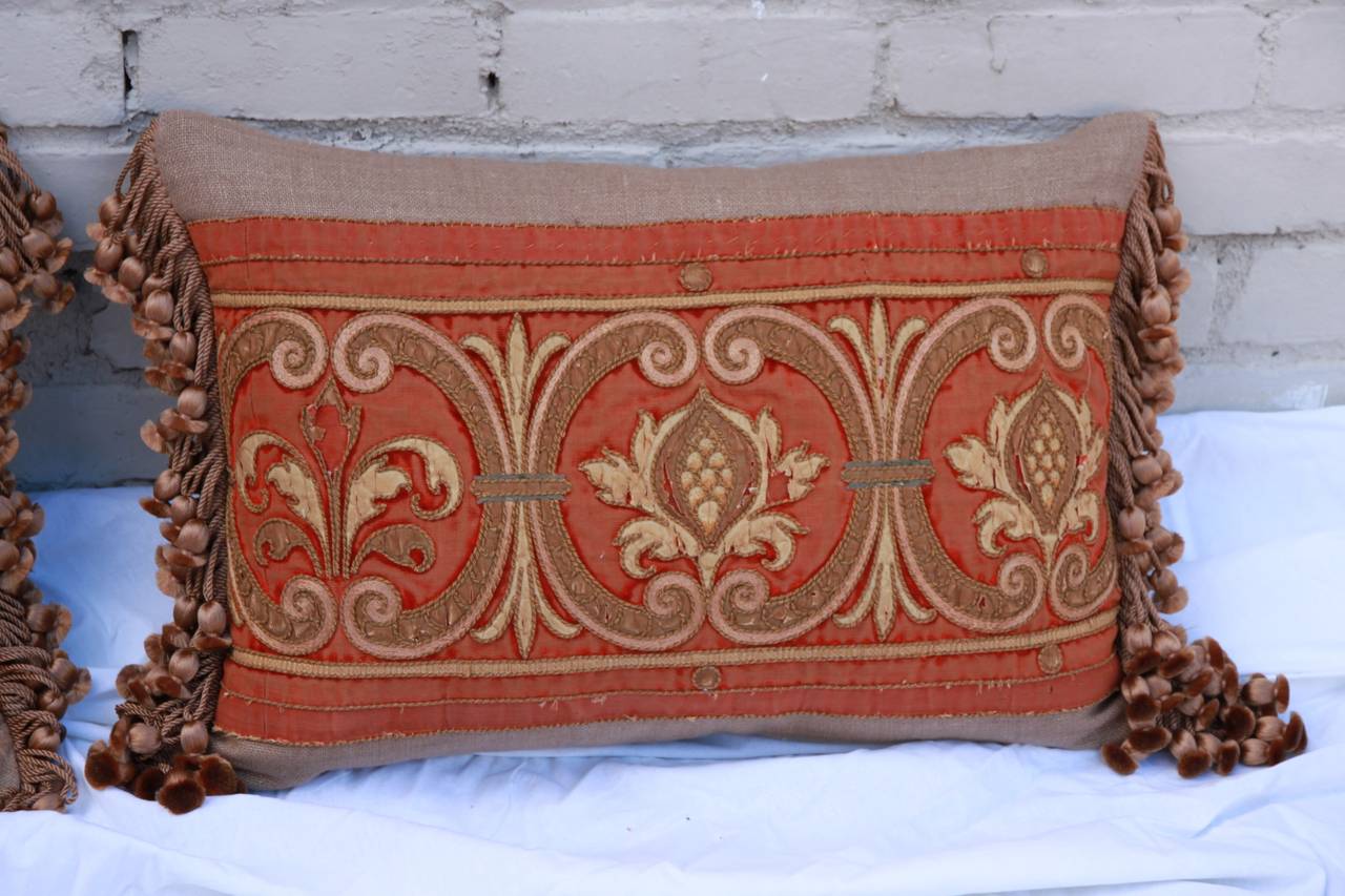 Pair of antique rust worn velvet metallic embroidered and appliquéd pillows by Melissa Levinson. Pillows constructed from 19th century French Velvet metallic appliquéd panel combined with contemporary linen and silk tassel trim from Decor de Paris.