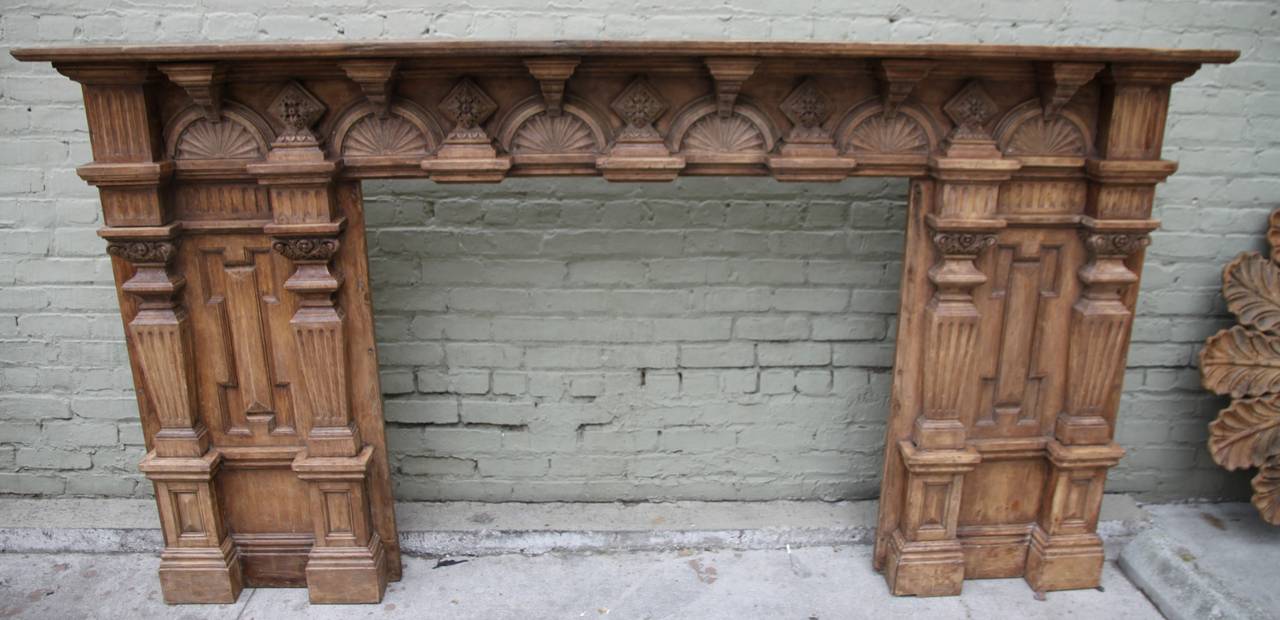 Monumental carved walnut fireplace mantel in neoclassical style with fluted columns, rosettes, and great carving throughout.

Opening 50