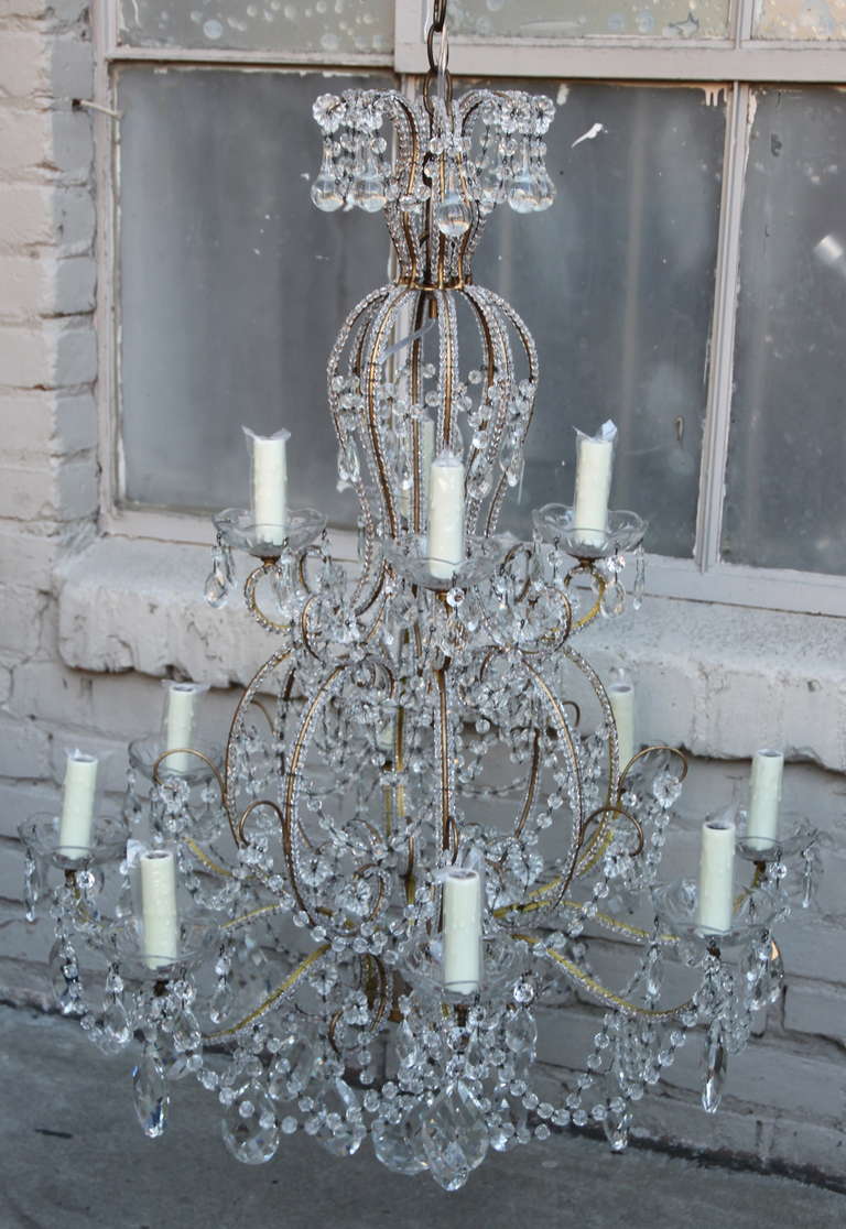Twelve light Italian style beaded arm crystal chandelier with drops. Newly wired with chain and canopy.