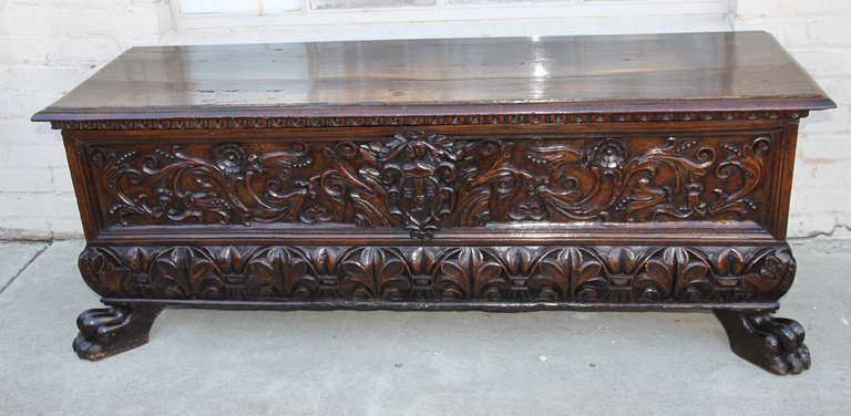 19th century walnut carved cassone with front lion feet.