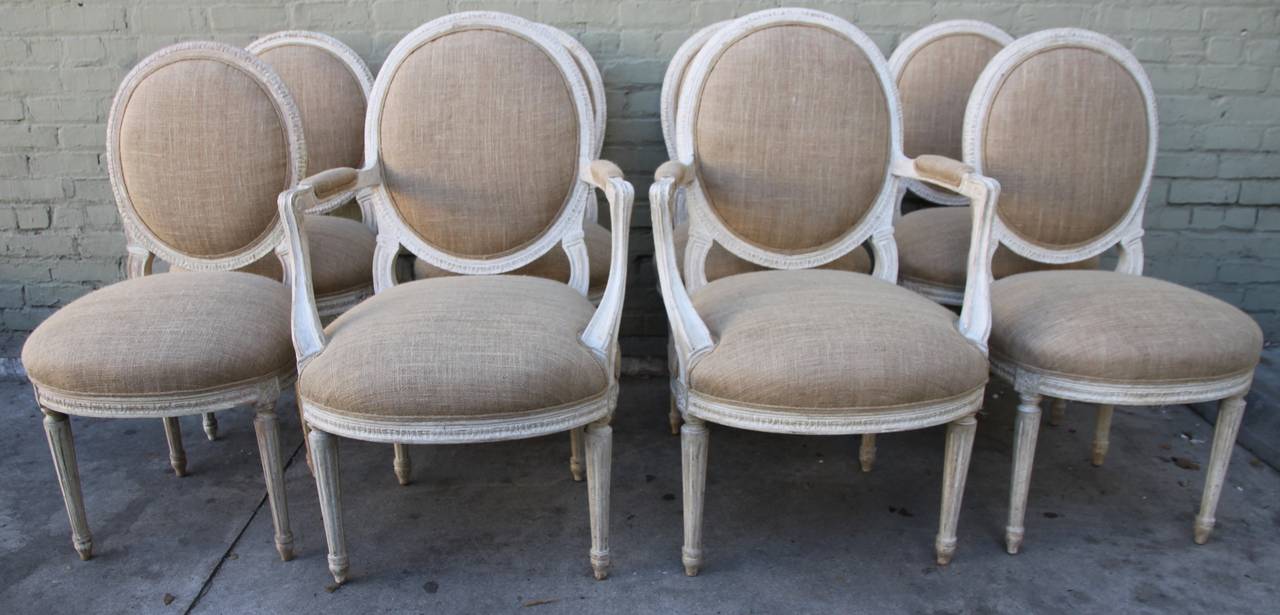 Set of eight Italian painted dining chairs newly upholstered in burlap textile with self cord detail. Size armchairs: 25