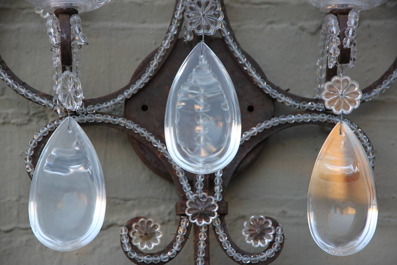 Pair of three light crystal beaded & wrought iron wall sconces.  Newly wired and in working condition.