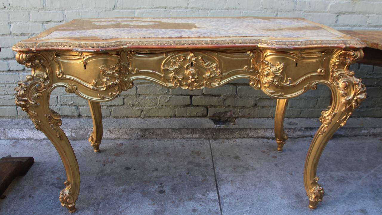 Fine Rococo style Italian 19th century carved & gilt writing table with inset Onyx Top.