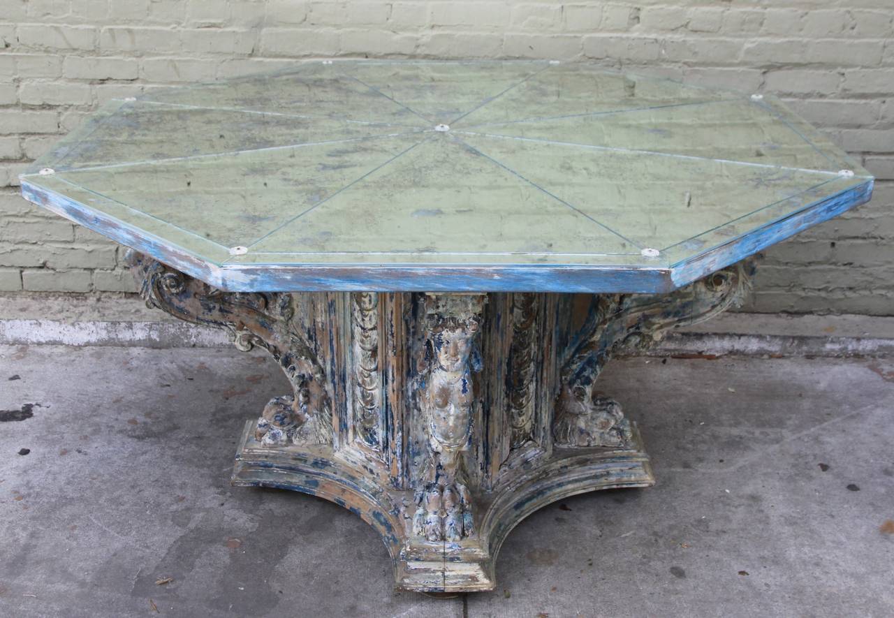Carved Italian octagonal carved painted table with antiqued mirrored top.