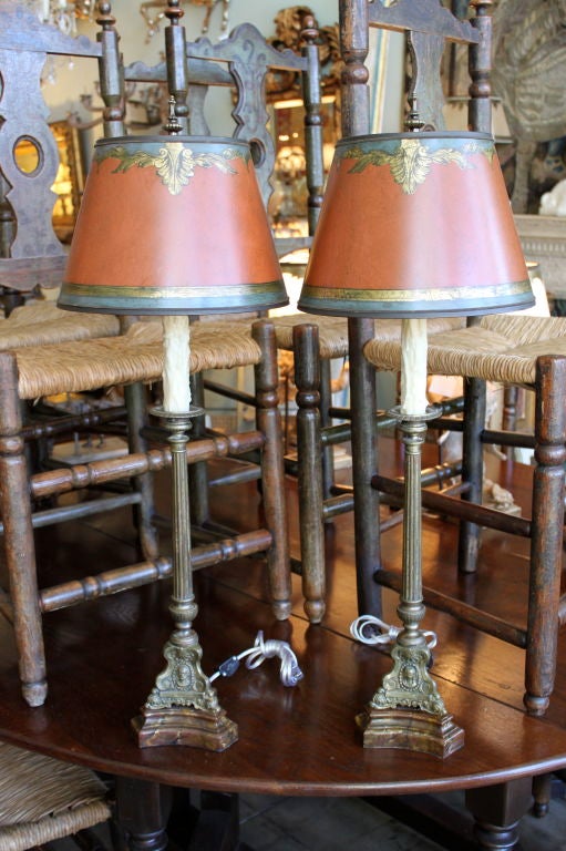 Pair of 19th century candlesticks wired into lamps with hand painted parchment terra cotta shades and faux marble bases.