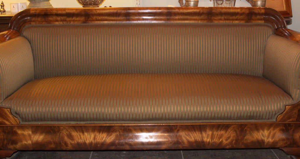 19th century Flame Mahogany veneer America Empire Sofa with new striped upholstery.