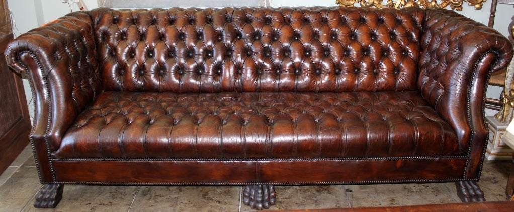 Grand Leather Tufted Chesterfield style sofa with nailhead trim detail and carved lion paw feet.