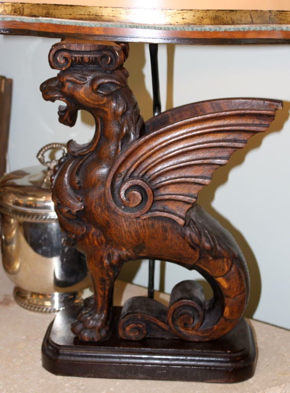 Pair of hand carved griffin lamps crowned with hand painted parchment shades.