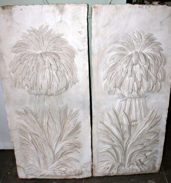 Unusual 19th century pair of carved marble panels depicting bunches of wheat.  These were said to have originally been the property of William Randolph Hearst.