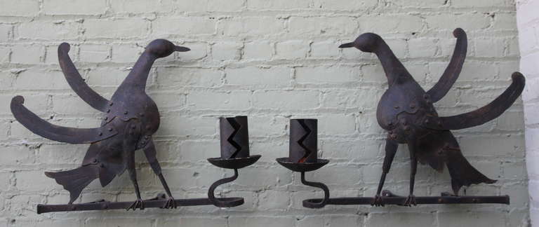 Pair of Spanish wrought iron candle holders. They can be mounted to a wall or can stand by themselves on a table.