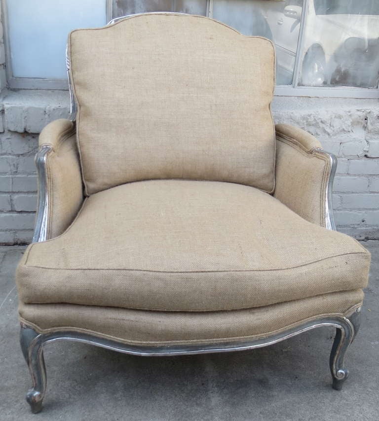 Pair of grand scale Louis XV style soft blue/grey painted and silver gilt Bergeres with back stretcher. New Belgium linen upholstery with down envelope cushions- Loose seat and back. Double cording.