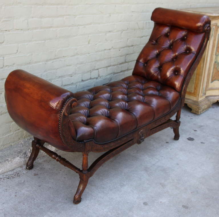 French walnut leather tufted chaise lounge with nailhead trim detail.