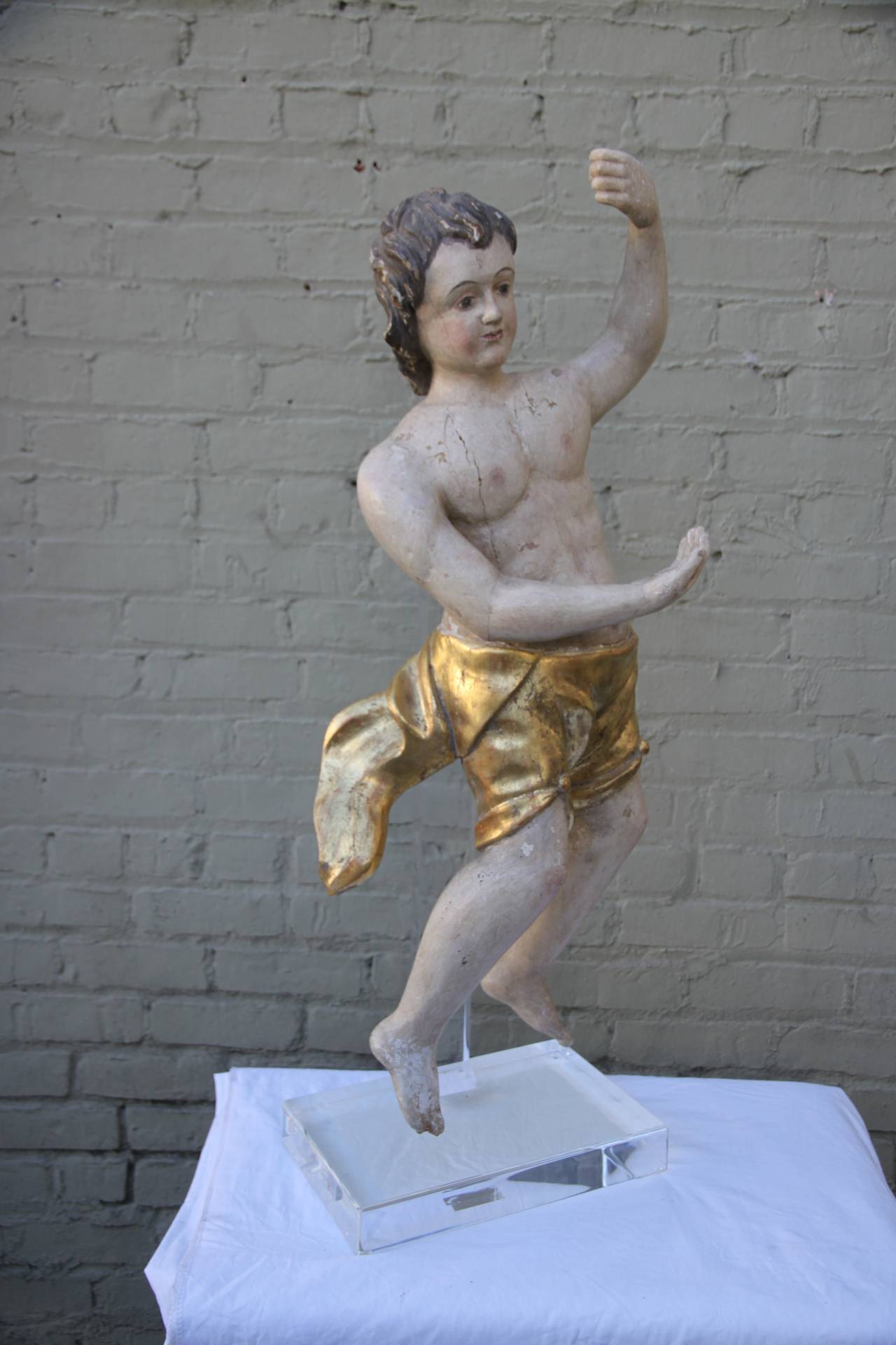 19th century Italian carved statue of polychromed and giltwood figure on Lucite base.