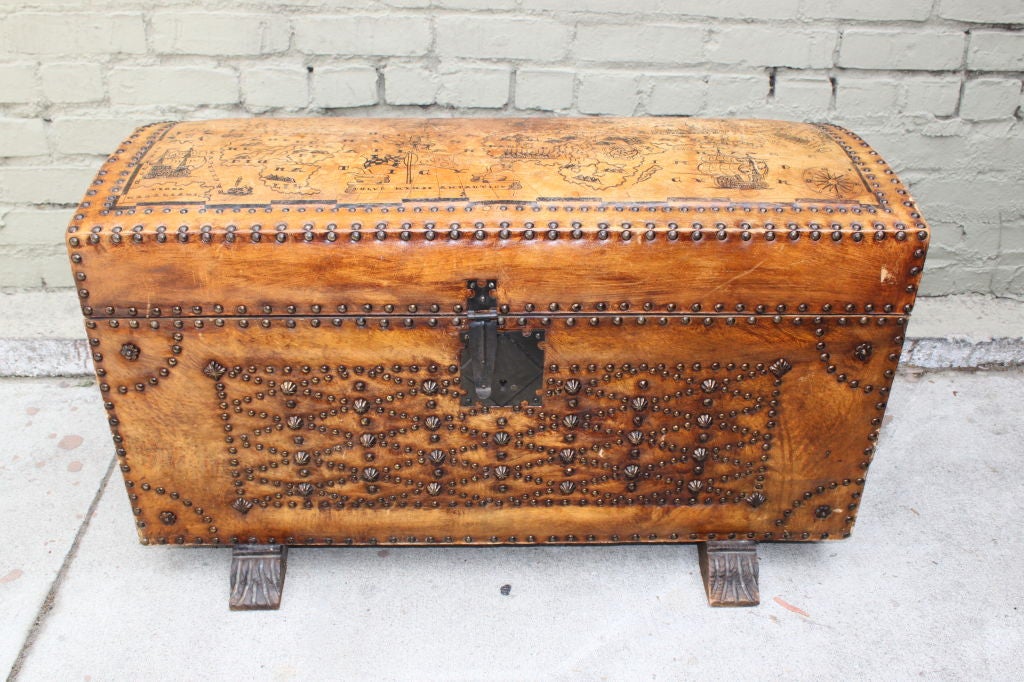 Spanish studded leather trunk standing on carved feet.  Wrought Iron Lock and handles.