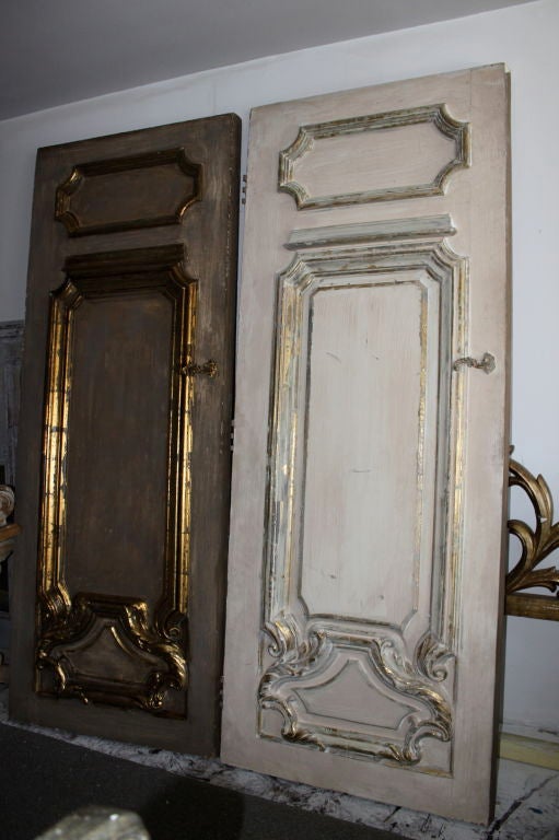 Pair of stunning painted and parcel gilt doors with brass handles.