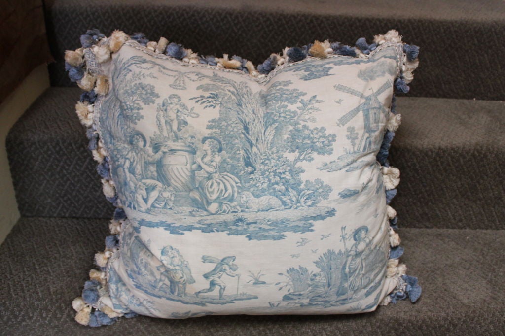 Pair of blue & white French toile pillows with blue velvet backs and multi-colored tassel fringe.