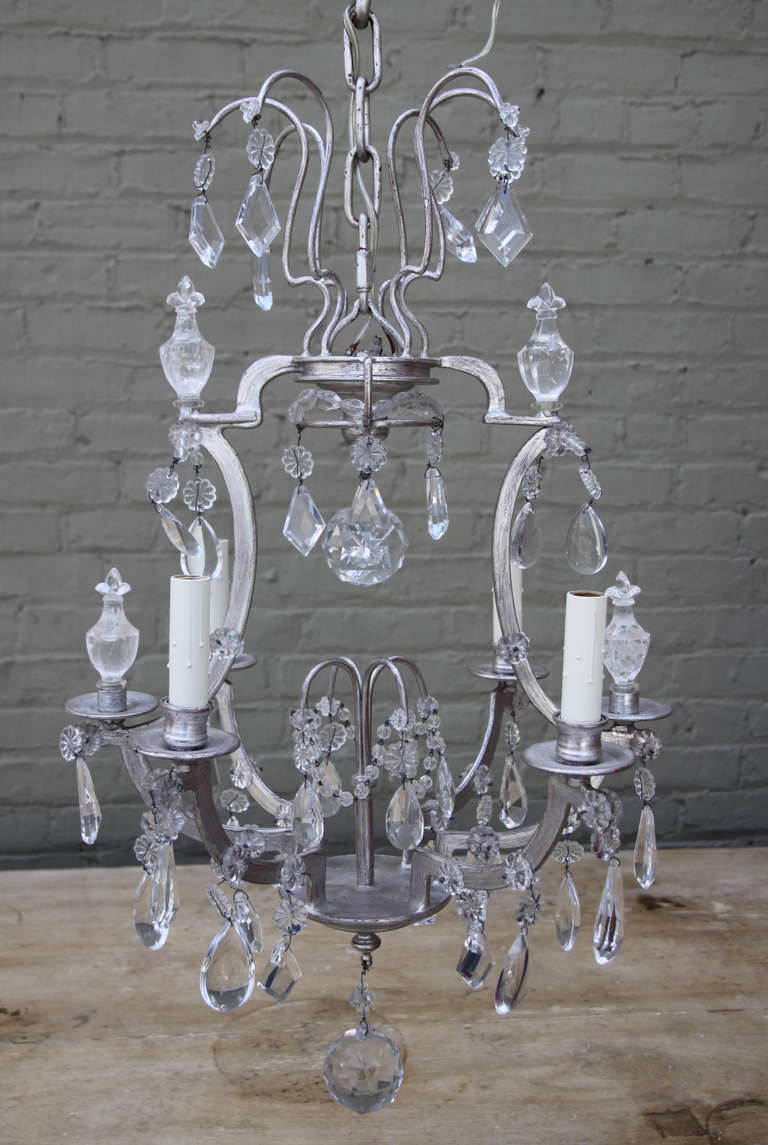 Silver gilt metal four light crystal chandelier with rock crystal finials w/ fleur de lis.  Newly wired and in working condition.