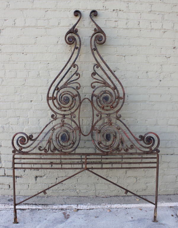 Stunning pair of hand wrought iron headboards with a stunning patina and unusual design.  The bottom section can easily be upholstered.