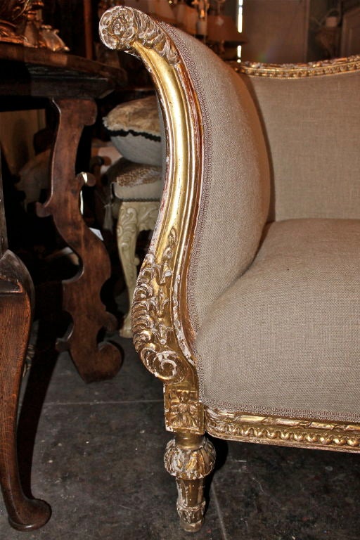 Carved Gilt Wood sofa upholstered in Belgium linen with gimp trim detail.