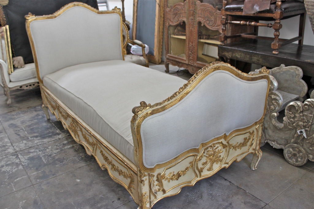 Venetian carved painted & parcel gilt bed reupholstered in Belgium linen.