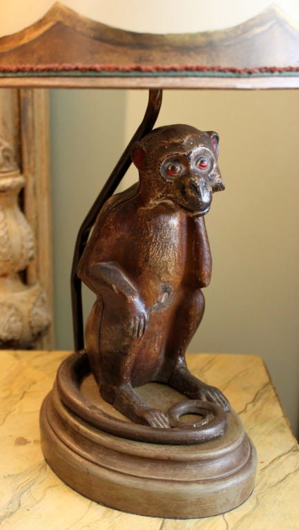 Charming painted metal monkey French mounted into a lamp and crowned with a hand painted parchment shade.