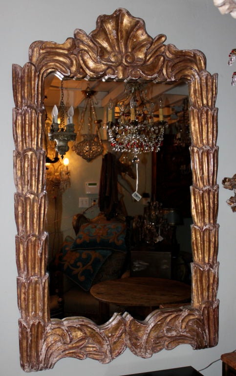 Italian gilt wood mirror depicting a center shell motif.
