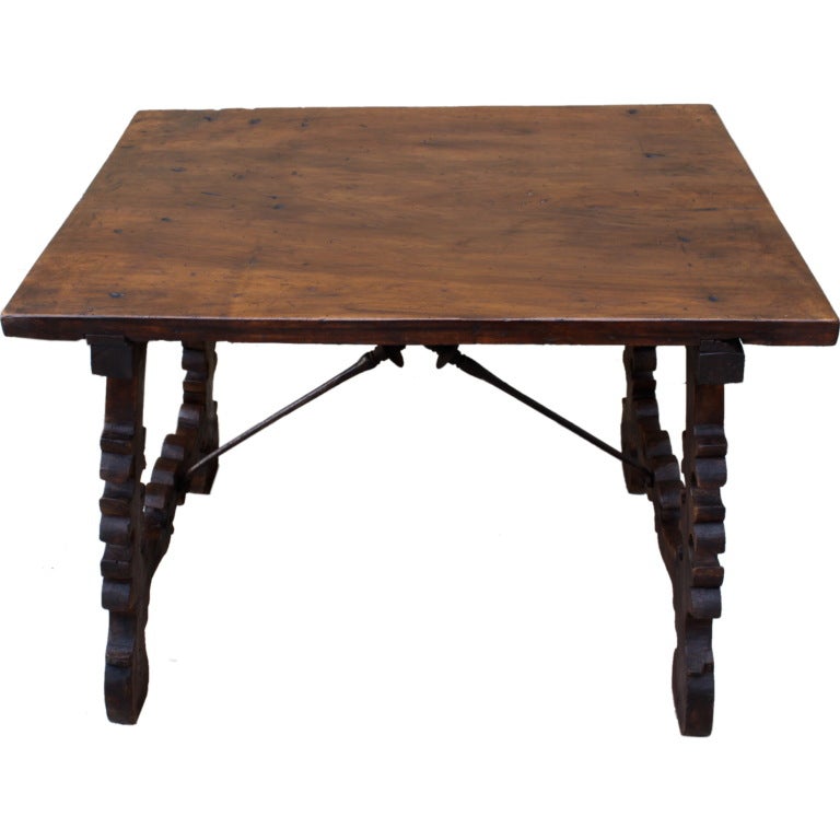 19th century carved walnut Spanish table with crossed iron stretcher.