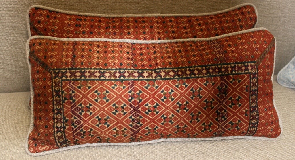 Pair of rust colored vintage textile pillows.  The textile was made in India by the Mwong people.  The backs of the pillows are made from Belgium linen.  Down & feather inserts.
