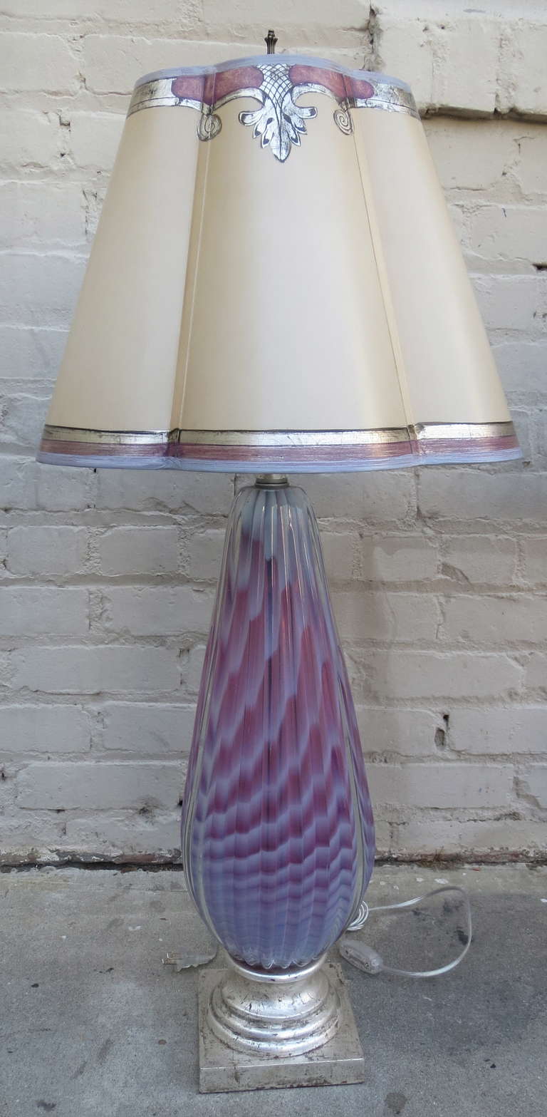 Pair of handblown unique colored iridescent glass Murano lamps with silver leaf metal bases.  The lamps are crowned with beautiful custom scalloped hand painted parchment shades.  The lamps are newly rewired and in working condition.