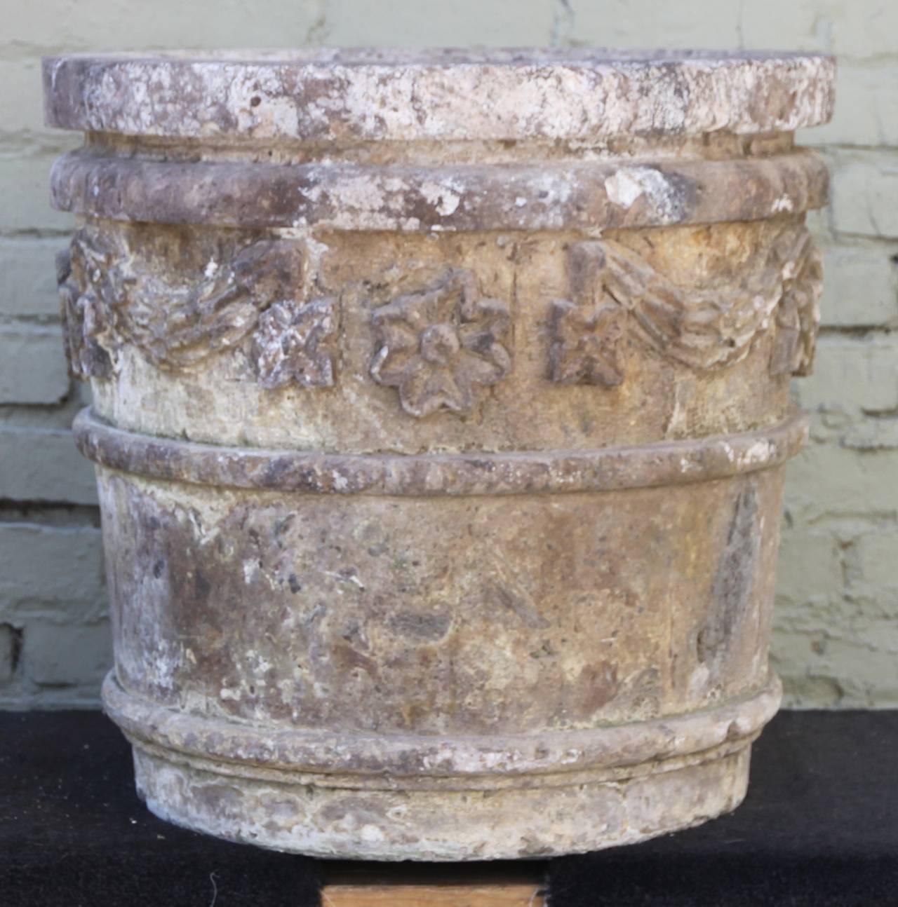 Pair of monumental scale stone planters with floral motif.