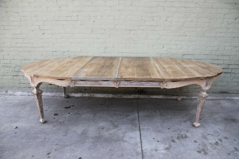Oval French White Washed Dining Table w/ two leaves. Distressed finish with remnants of paint throughout.